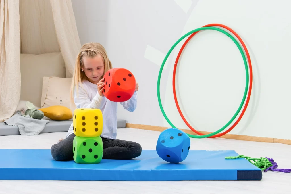 Stor skumterning sæt med 16 cm skumterninger. Pige leger med dem i skole.